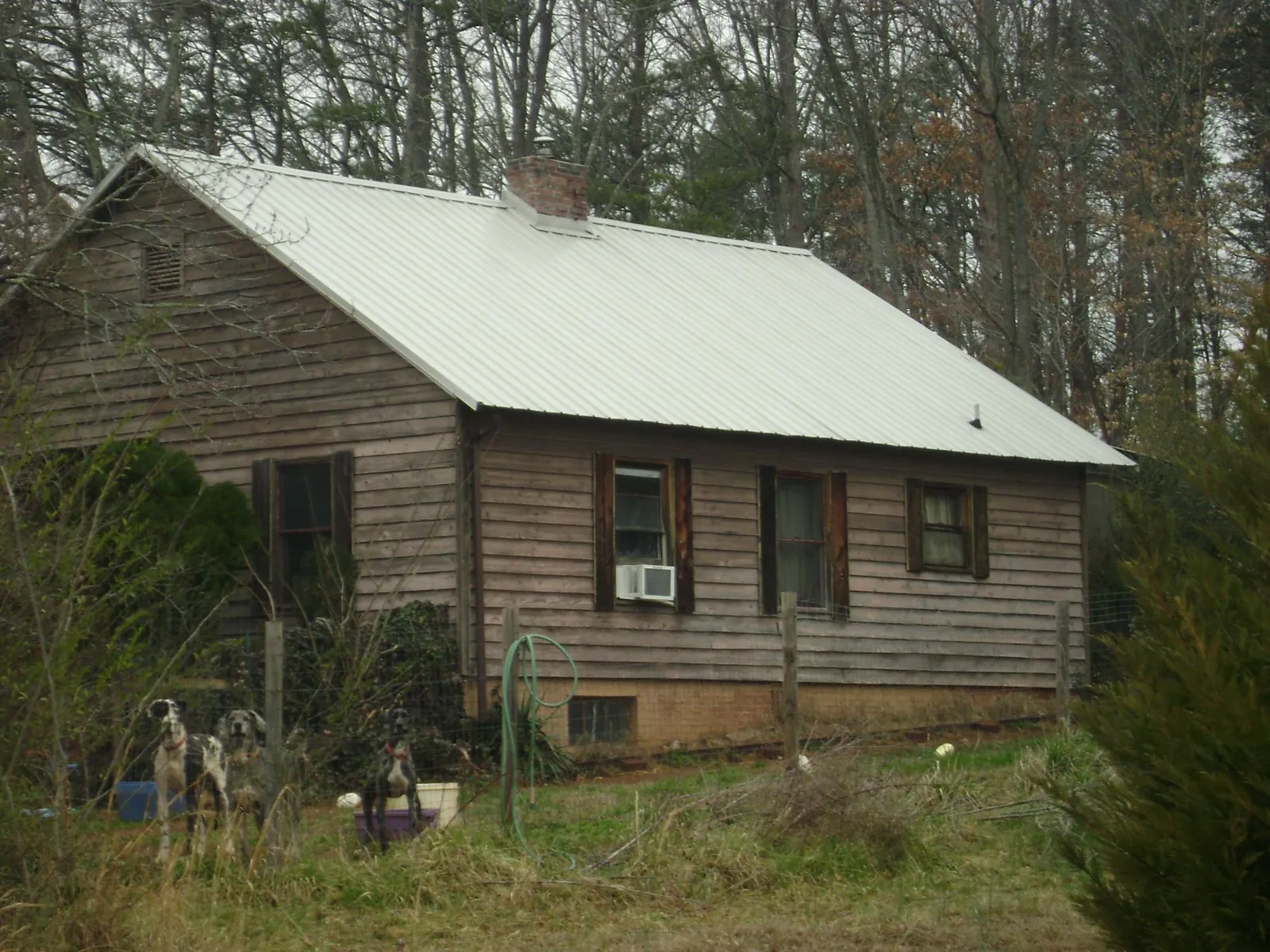 White metal roof on an old wood sided farmhouse, from a Asphalt Shingle Roof Repair job in Teaneck